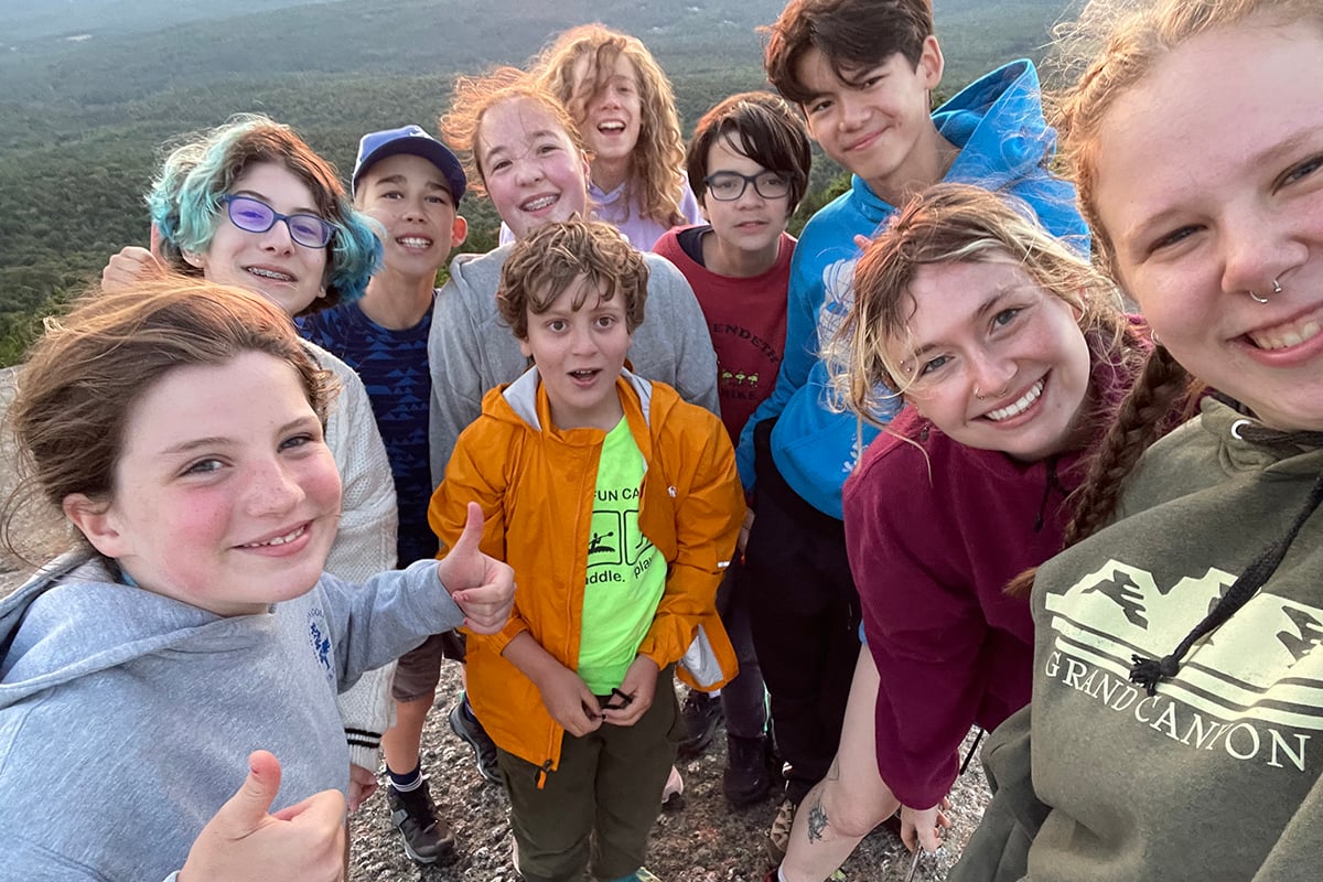 Group of teens on top of a mountain