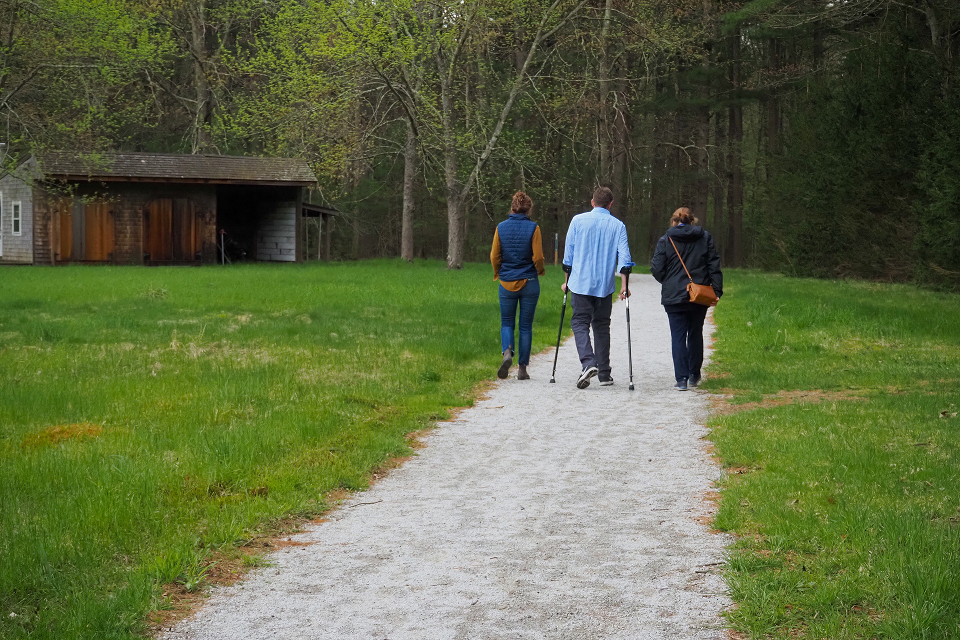 Three people walking along the All Persons Trail