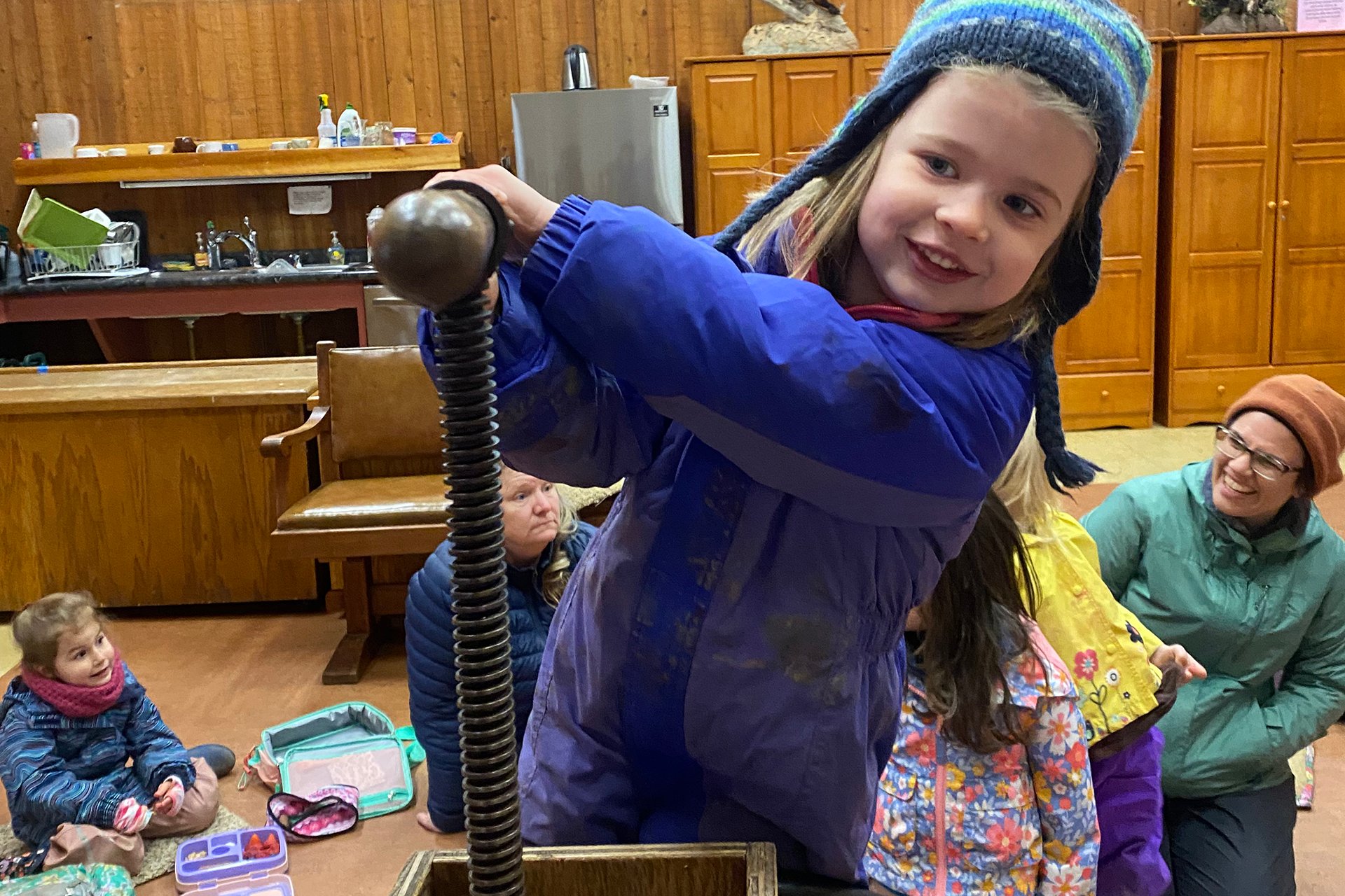 Preschooler using an old-fashioned apple press