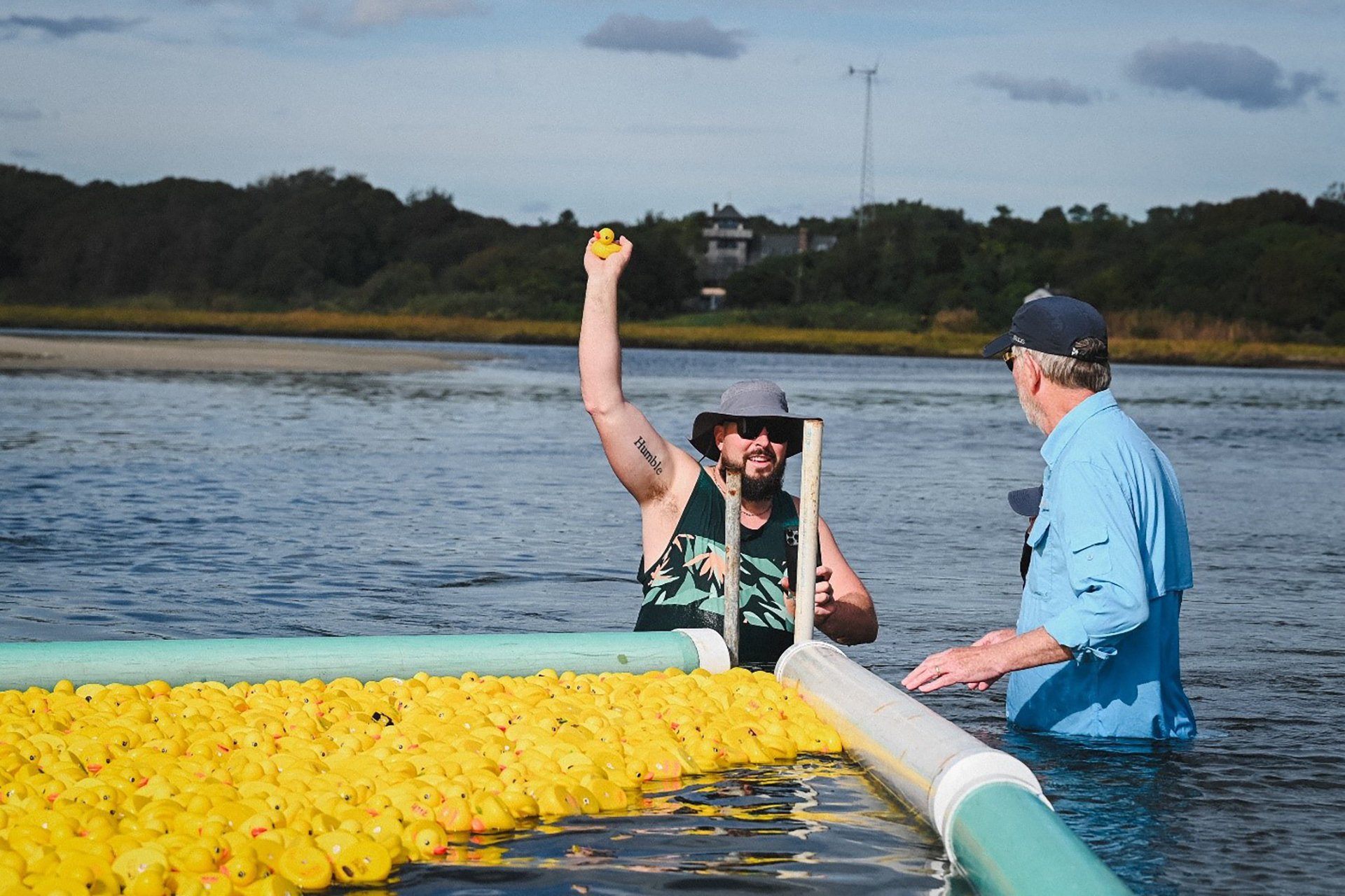 Duck Derby crew member holding up the winning rubber duck