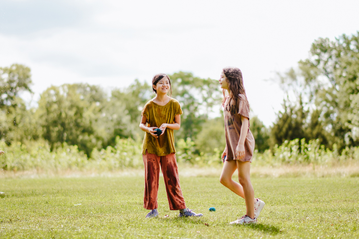 Two campers standing in a field