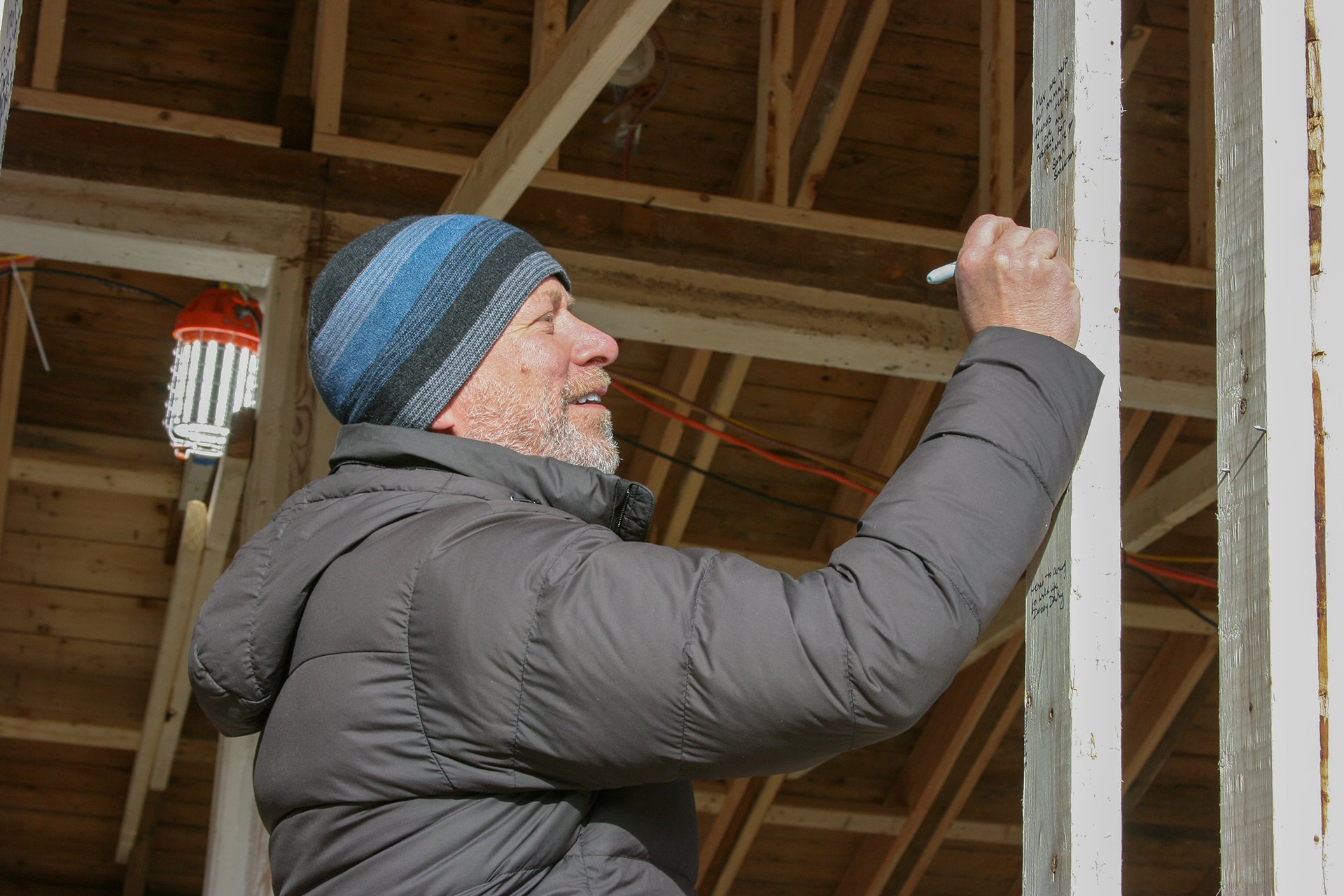 David O'Neill signing one of the beams at Drumlin's Wildlife care center