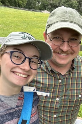 daughter and father smiling at camera