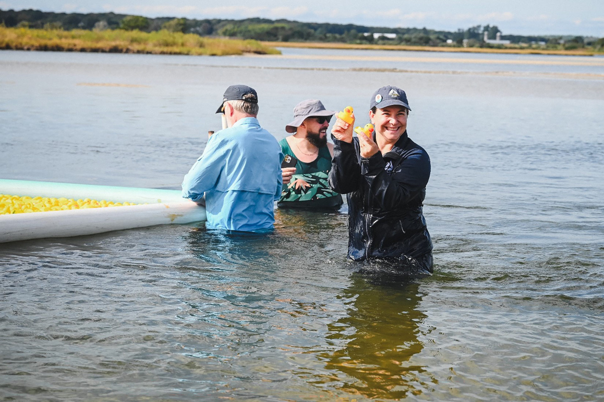 duck derby crew member holding up rubber ducks